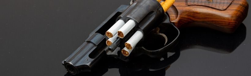 Revolver noir et marron chargé avec des cigarettes