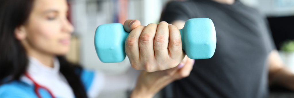Man on stroller doing exercises with dumbbells