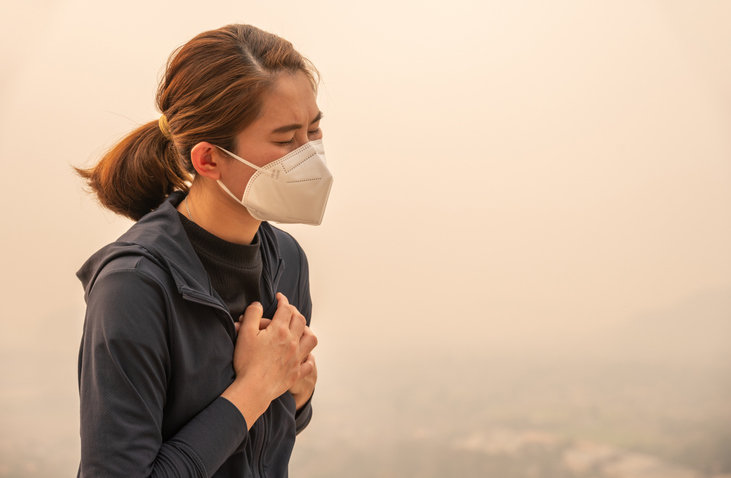 Asian woman having respiratory allergy caused of by Bad air pollution (PM2.5).